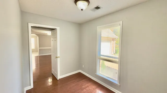a view of an empty room with a window