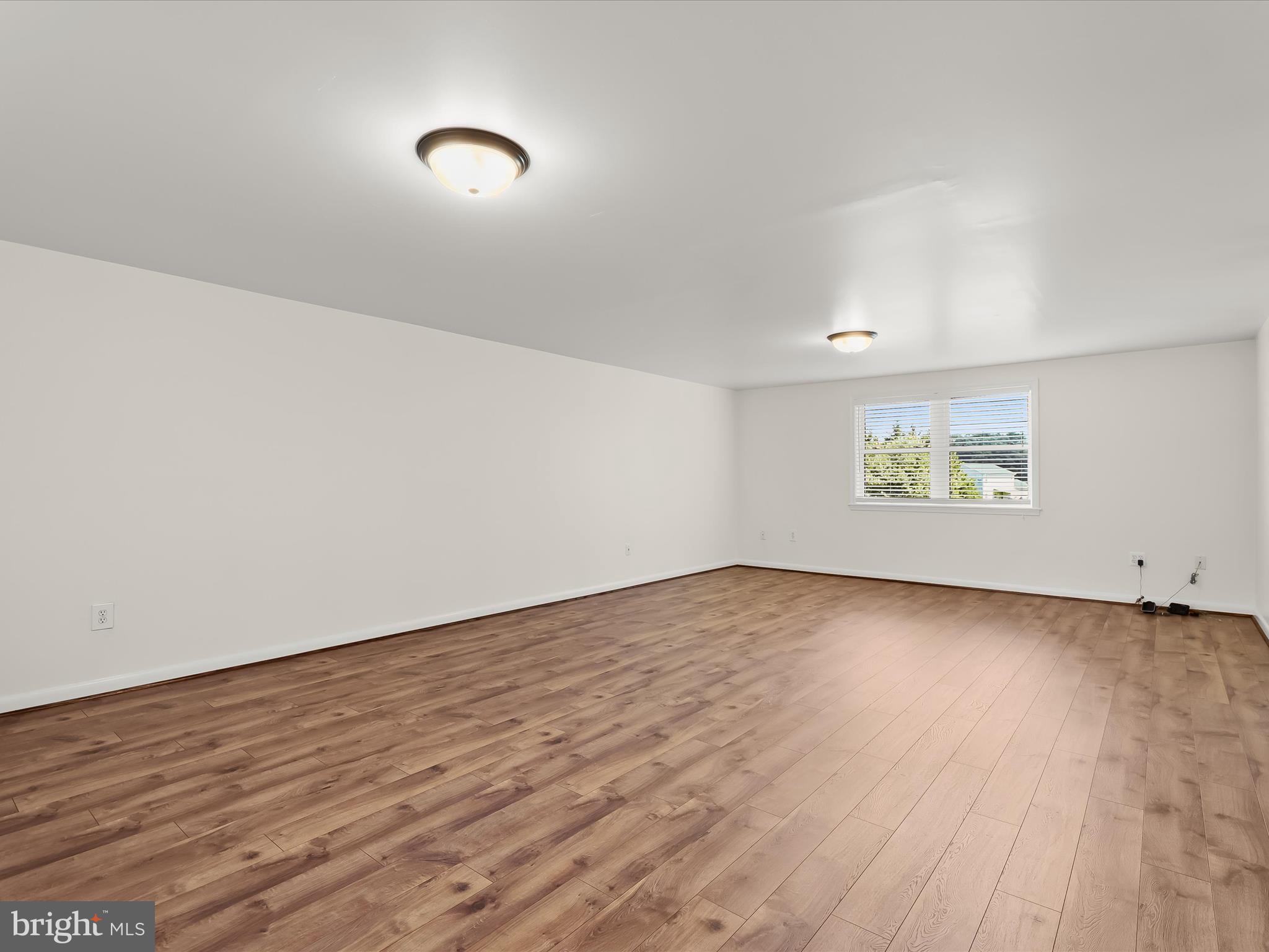 2913 Duncan Road White Hall, MD 21161 - Photo 59 of 85 an empty room with wooden floor and windows