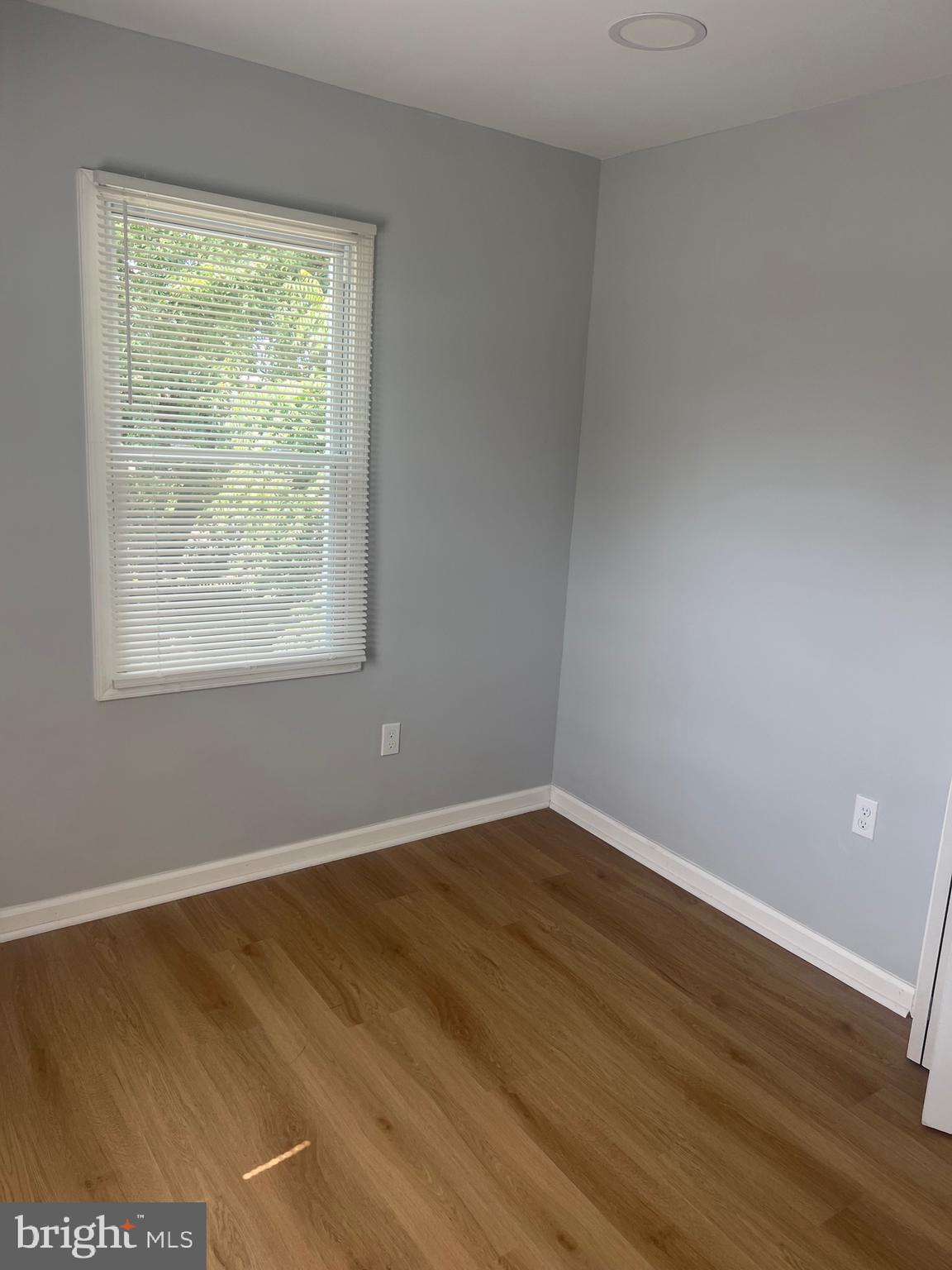 1208 Congress Street Southeast Washington, DC 20032 - Photo 6 of 12 an empty room with wooden floor and windows