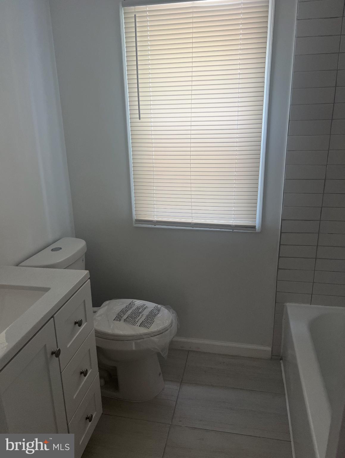 1208 Congress Street Southeast Washington, DC 20032 - Photo 7 of 12 a bathroom with a toilet sink and mirror