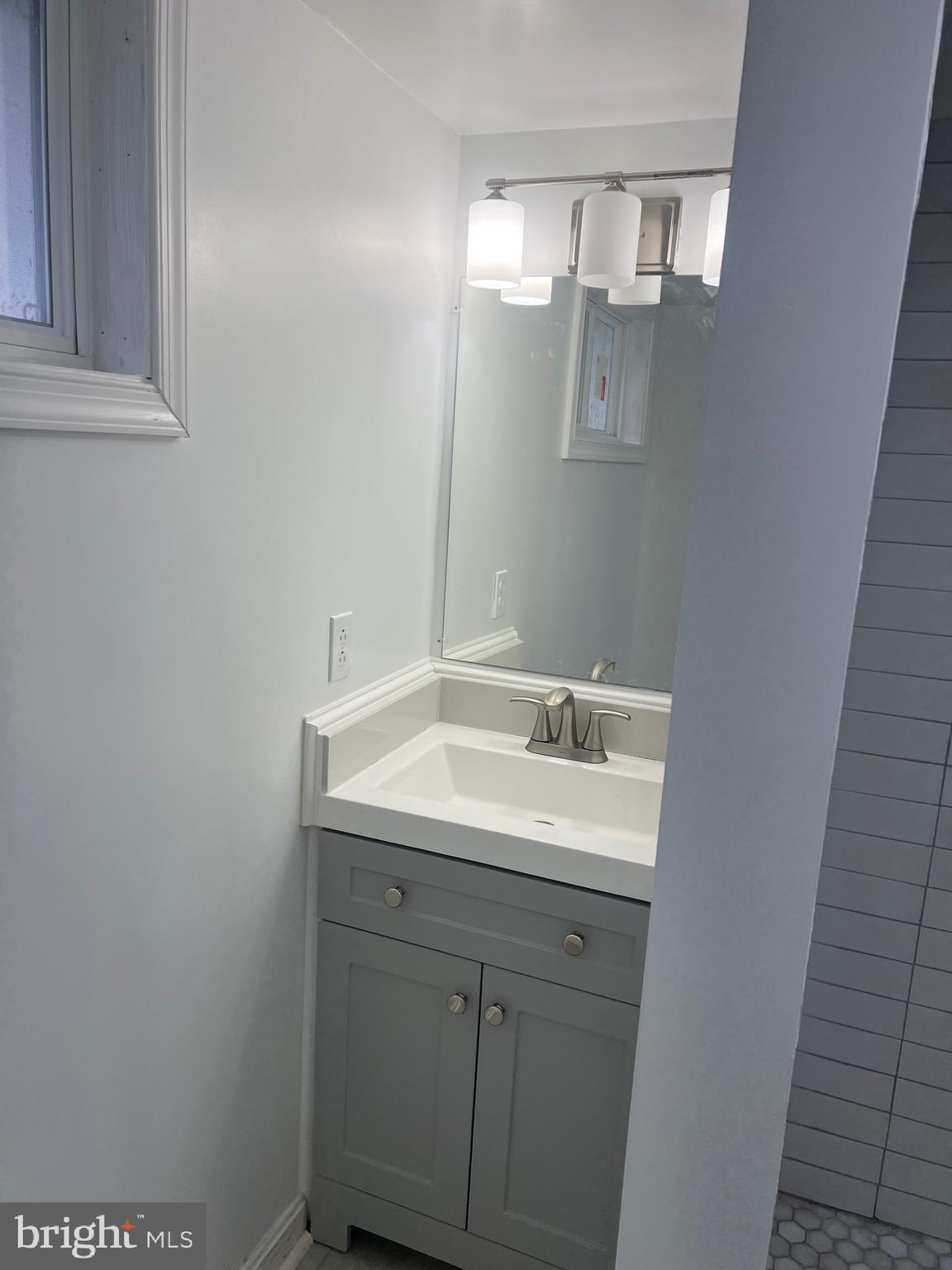 1208 Congress Street Southeast Washington, DC 20032 - Photo 9 of 12 a bathroom with a sink and mirror