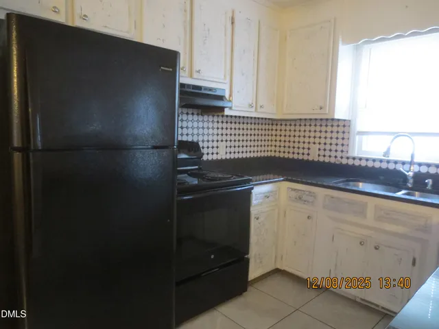 a kitchen with a sink and a refrigerator