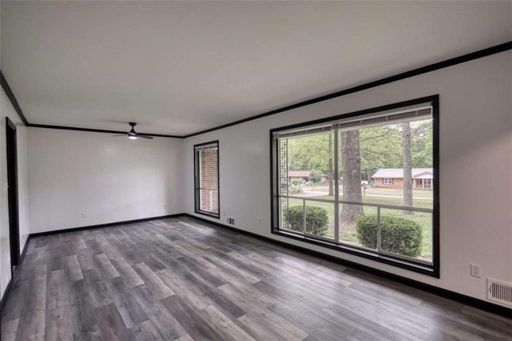 555 Joy Street Jackson, GA 30233 - Photo 11 of 56 a view of a big room with wooden floor and windows