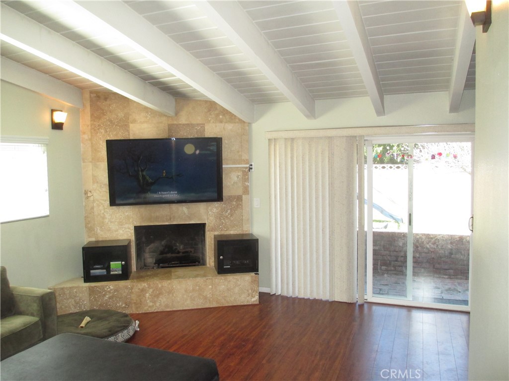 2281 Faust Avenue Long Beach, CA 90815 - Photo 11 of 41 a living room with furniture a flat screen tv and a fireplace