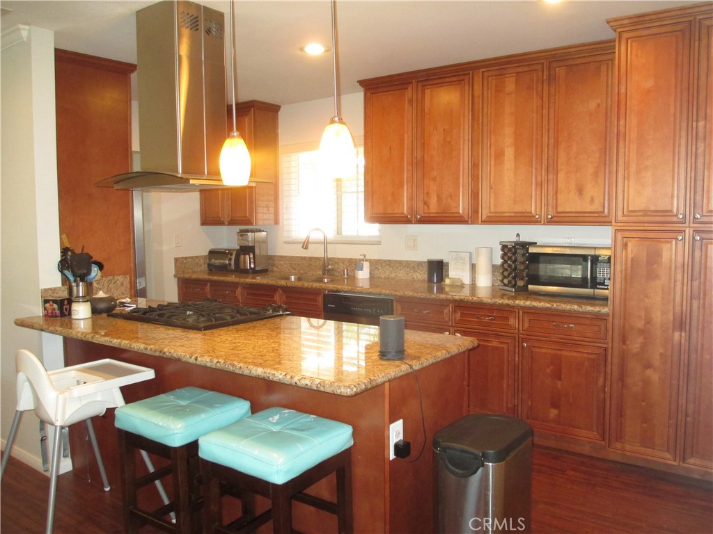 2281 Faust Avenue Long Beach, CA 90815 - Photo 13 of 41 a kitchen with granite countertop a sink stainless steel appliances and cabinets