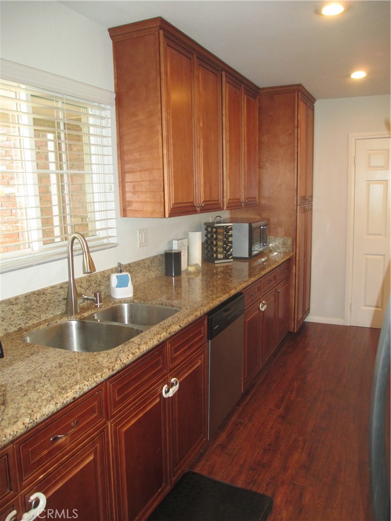 2281 Faust Avenue Long Beach, CA 90815 - Photo 17 of 41 a kitchen with stainless steel appliances granite countertop a sink a counter space and cabinets