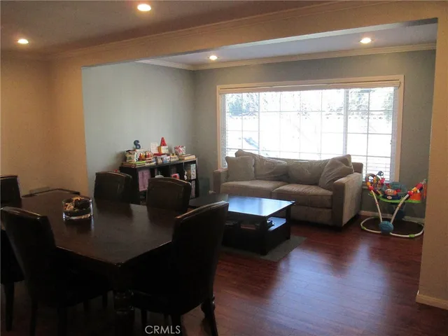 a living room with furniture window and wooden floor