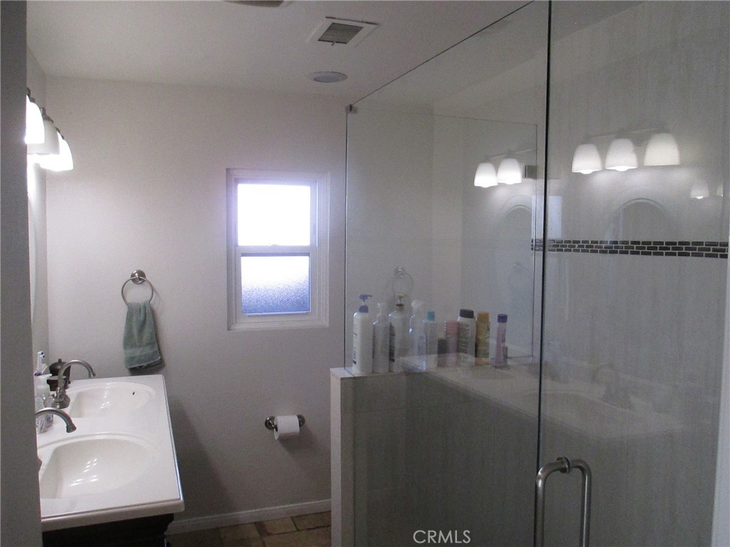 2281 Faust Avenue Long Beach, CA 90815 - Photo 24 of 41 a bathroom with a sink and mirror