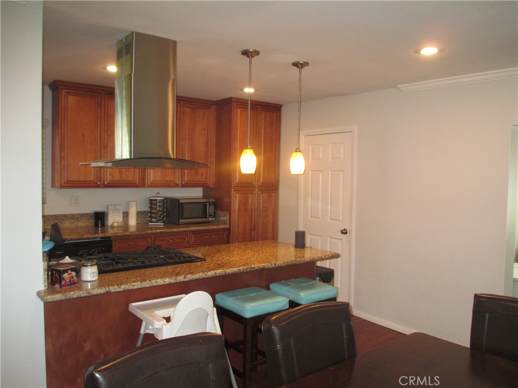 2281 Faust Avenue Long Beach, CA 90815 - Photo 30 of 41 a kitchen with granite countertop a refrigerator a sink and a stove