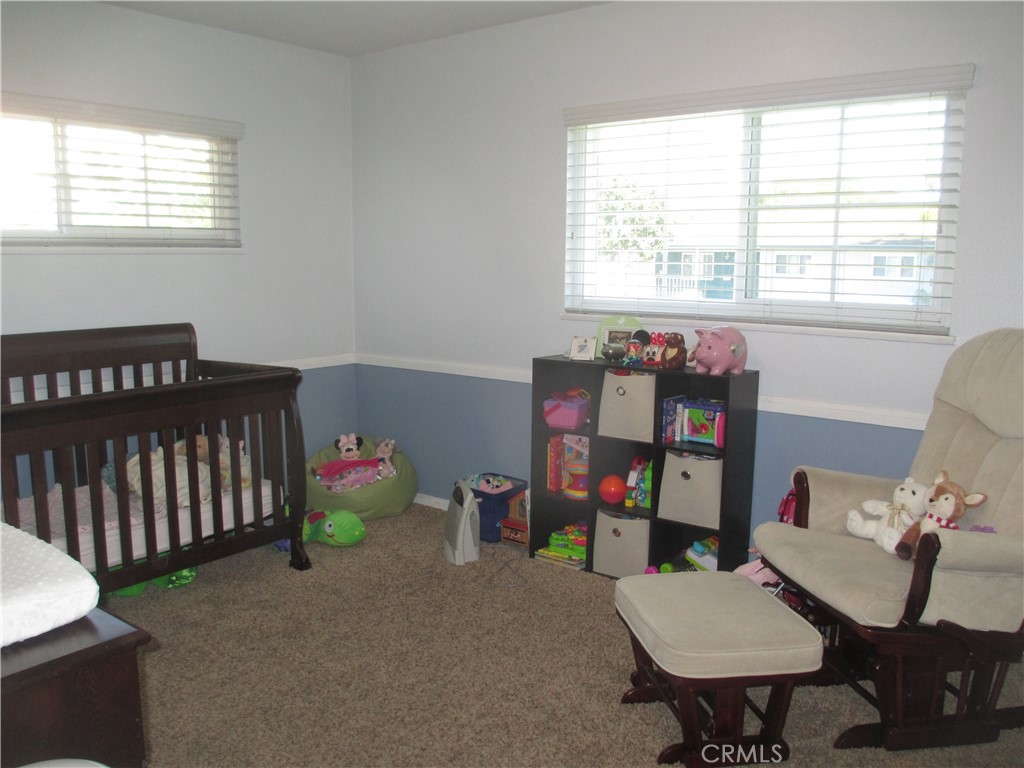 2281 Faust Avenue Long Beach, CA 90815 - Photo 31 of 41 a living room with baby crib furniture and a window