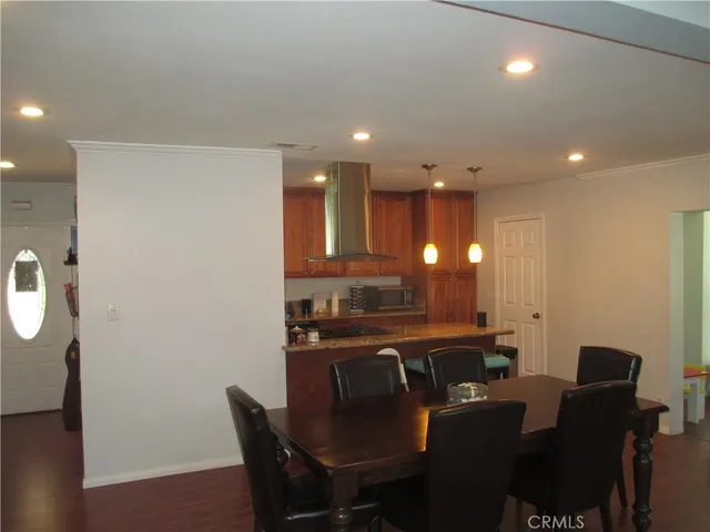 a kitchen with a table chairs and microwave