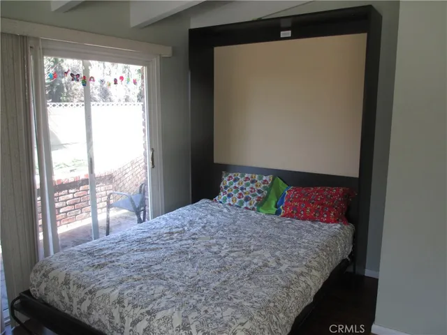 a bedroom with a large bed and a large window