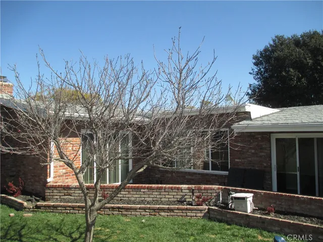a view of house with backyard
