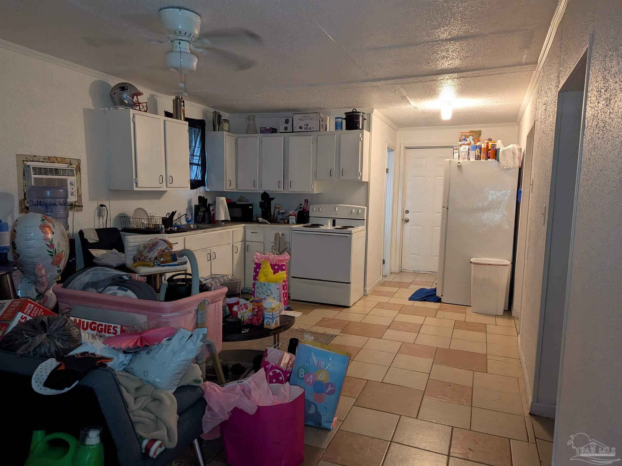 1036 Hawthorn Drive, Unit A/B Pensacola, FL 32507 - Photo 12 of 14 a kitchen with a refrigerator and a stove top oven