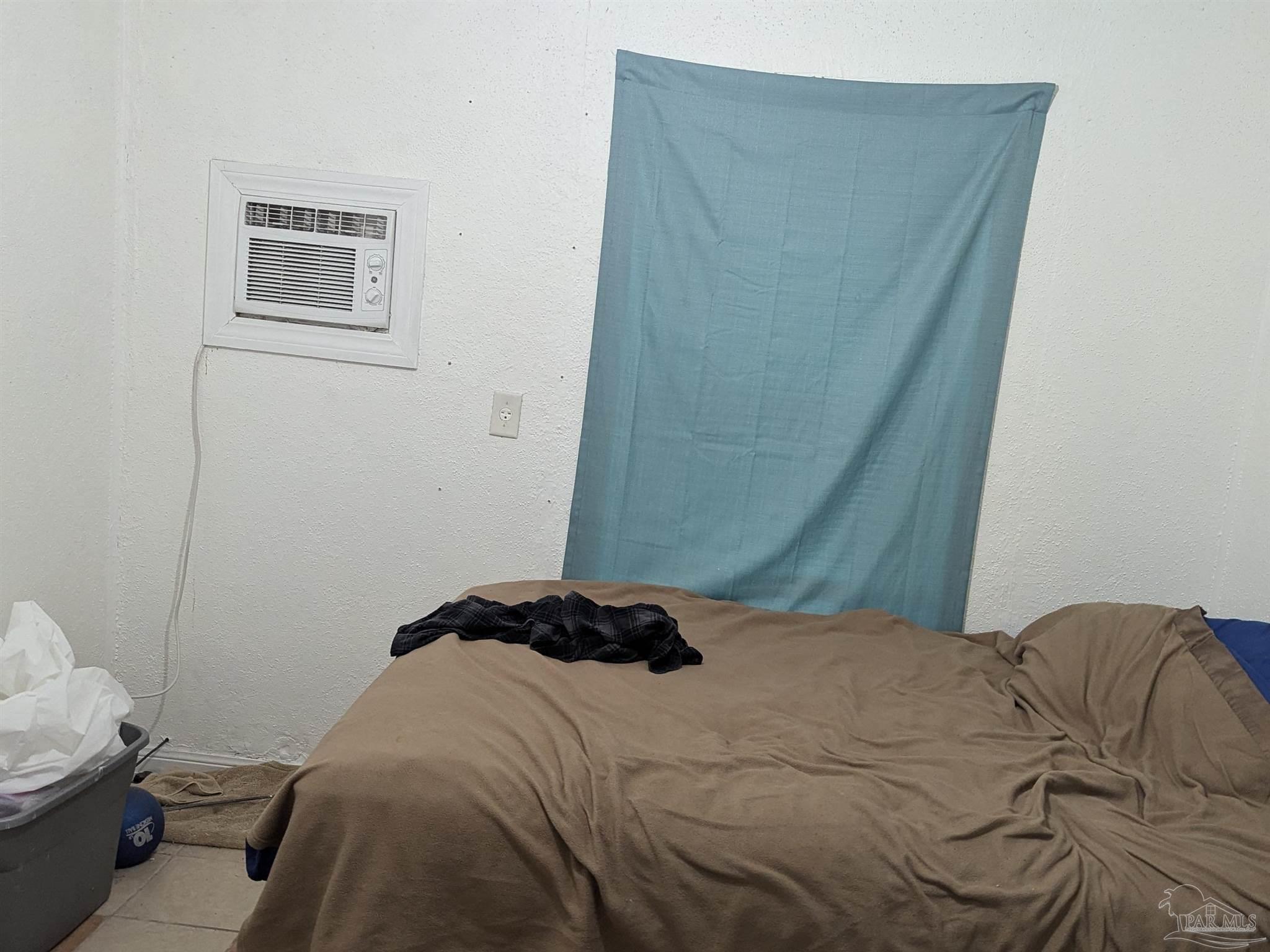 1036 Hawthorn Drive, Unit A/B Pensacola, FL 32507 - Photo 14 of 14 a bedroom with a bed and a window