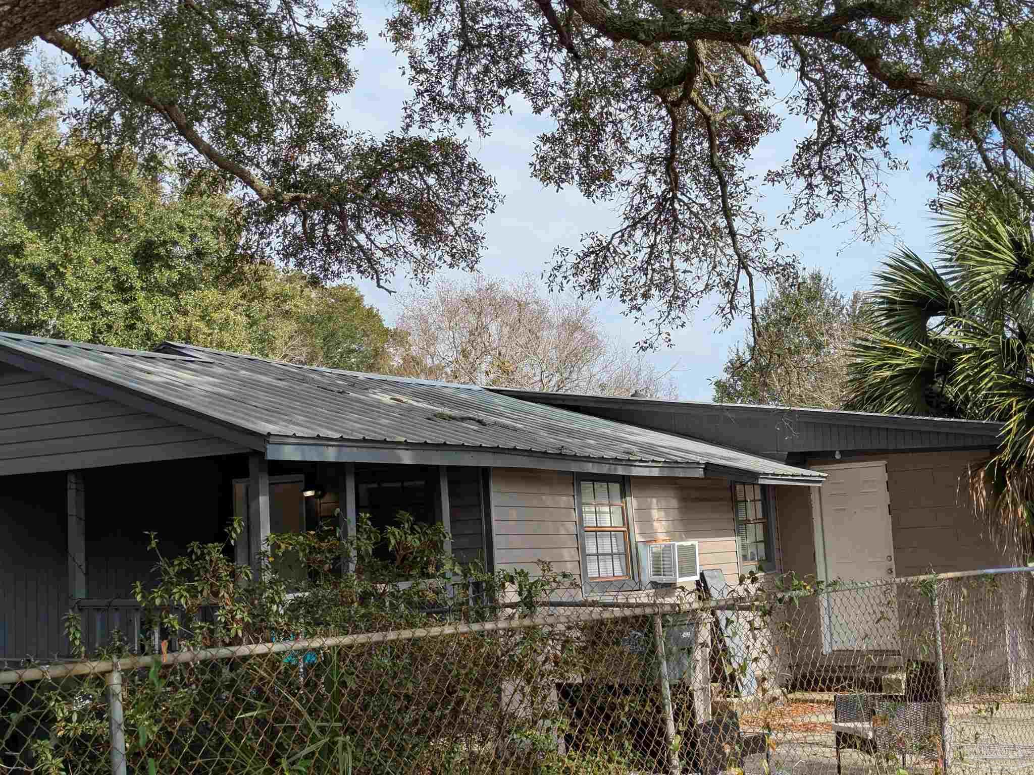 1036 Hawthorn Drive, Unit A/B Pensacola, FL 32507 - Photo 2 of 14 a front view of a house with garden