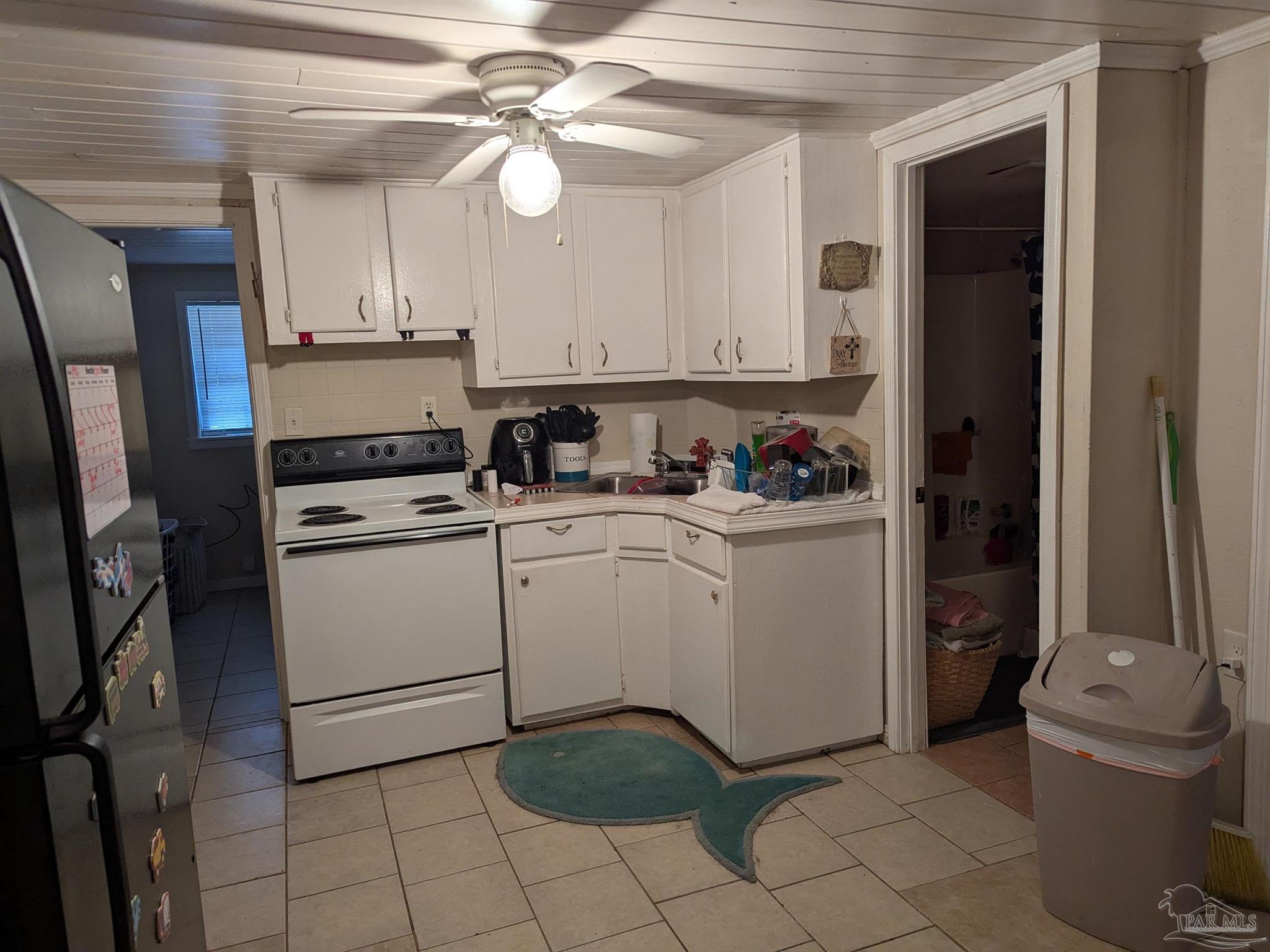 1036 Hawthorn Drive, Unit A/B Pensacola, FL 32507 - Photo 5 of 14 a utility room with cabinets dryer and washer