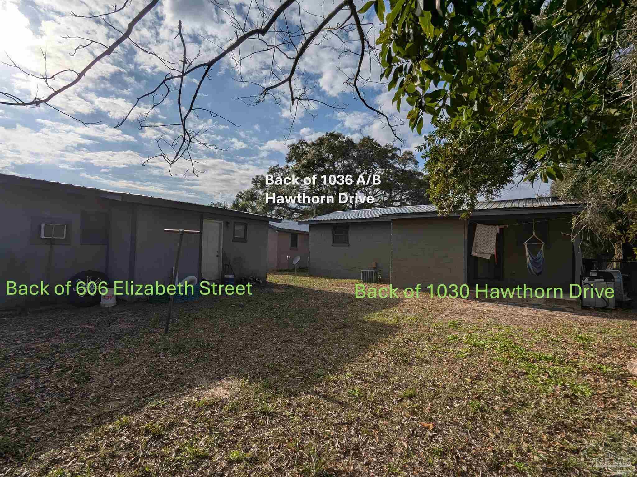 1036 Hawthorn Drive, Unit A/B Pensacola, FL 32507 - Photo 8 of 14 a backyard of a house with lots of green space