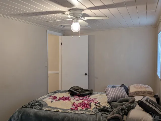 a kitchen with a refrigerator and a stove top oven