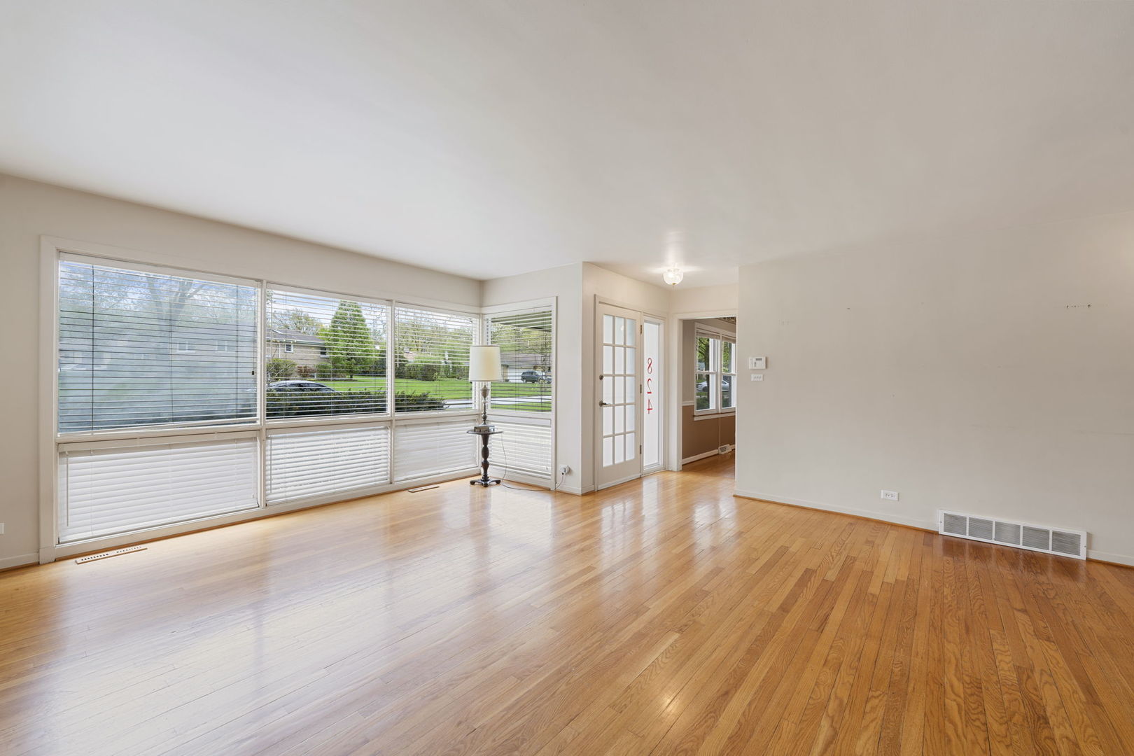 824 Braemar Road Flossmoor, IL 60422 - Photo 3 of 29 a view of an empty room with wooden floor and a window