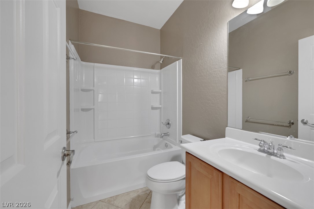 2501 Bechamel Place Henderson, NV 89044 - Photo 15 of 50 A well-maintained bathroom provides a pristine tub and shower combination with ample storage ledges.