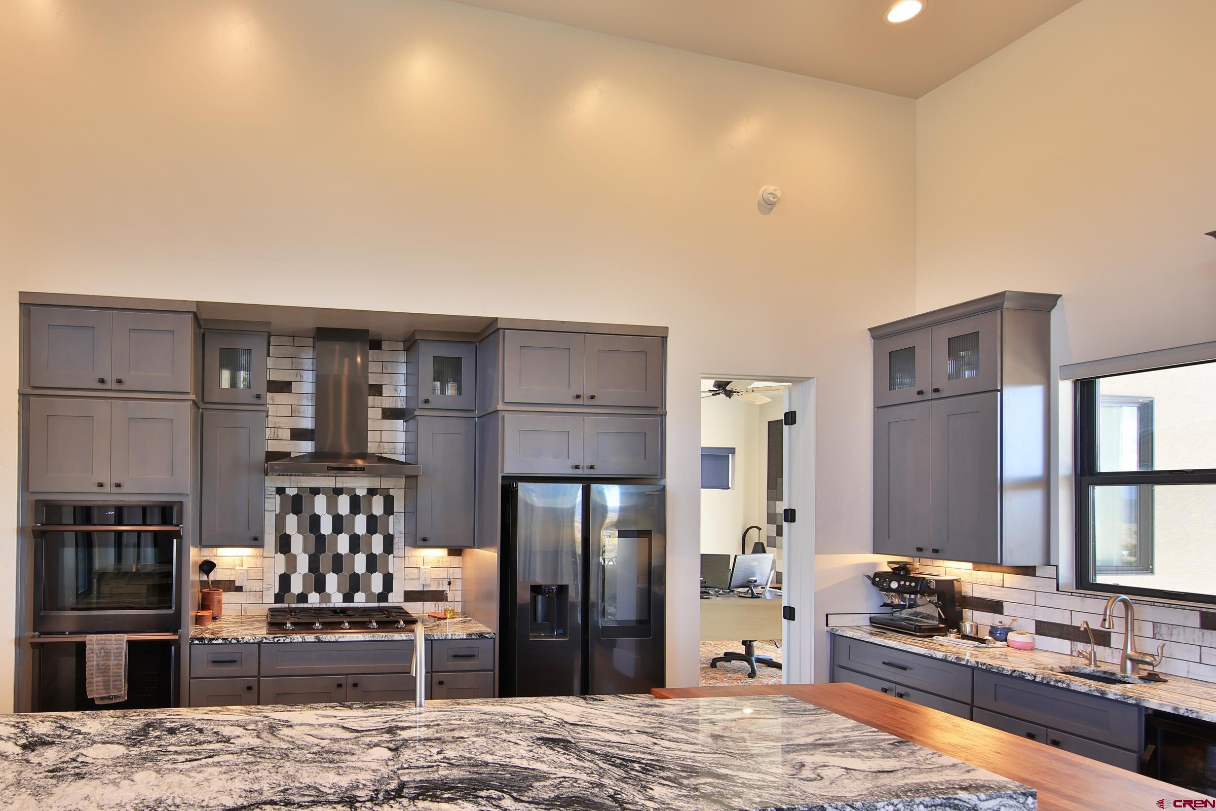 12471 54 7/10 Road Molina, CO 81646 - Photo 17 of 35 a large kitchen with stainless steel appliances kitchen island granite countertop a refrigerator and stove