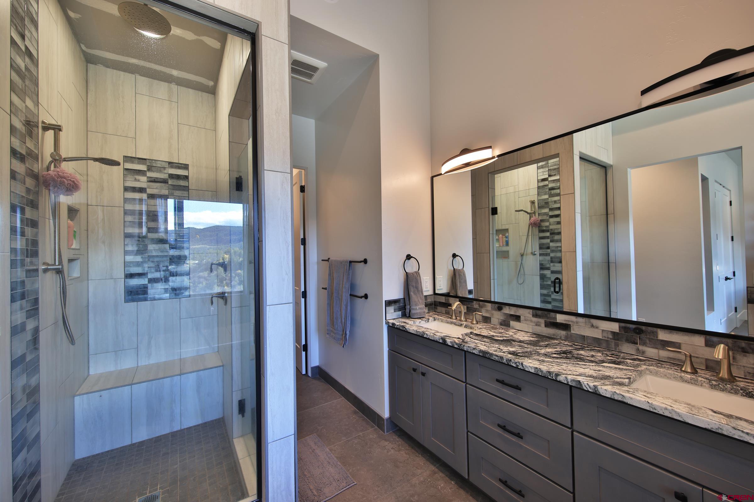 12471 54 7/10 Road Molina, CO 81646 - Photo 21 of 35 a bathroom with a granite countertop sink mirror and double