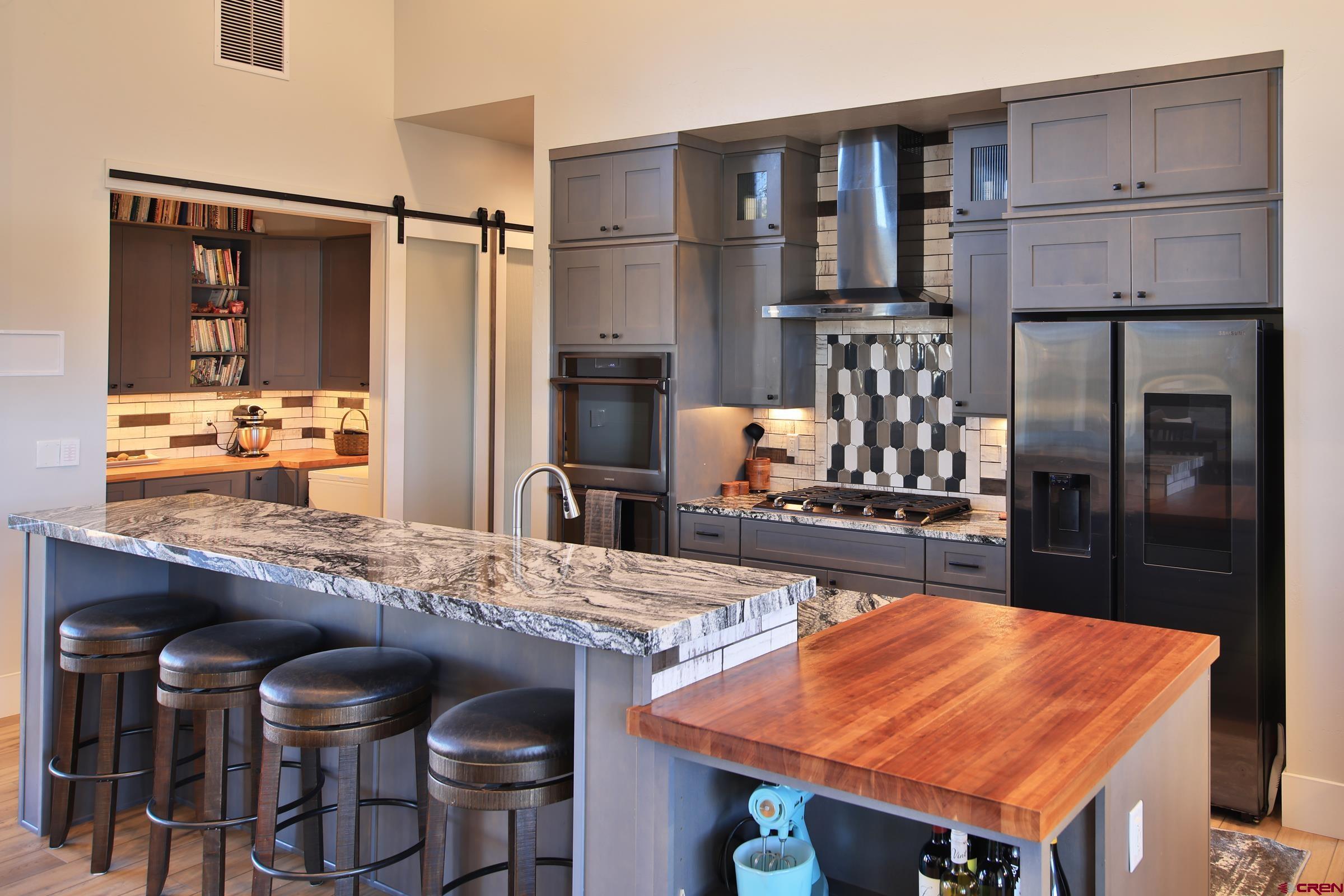 12471 54 7/10 Road Molina, CO 81646 - Photo 23 of 35 a kitchen with stainless steel appliances granite countertop a sink refrigerator and cabinets