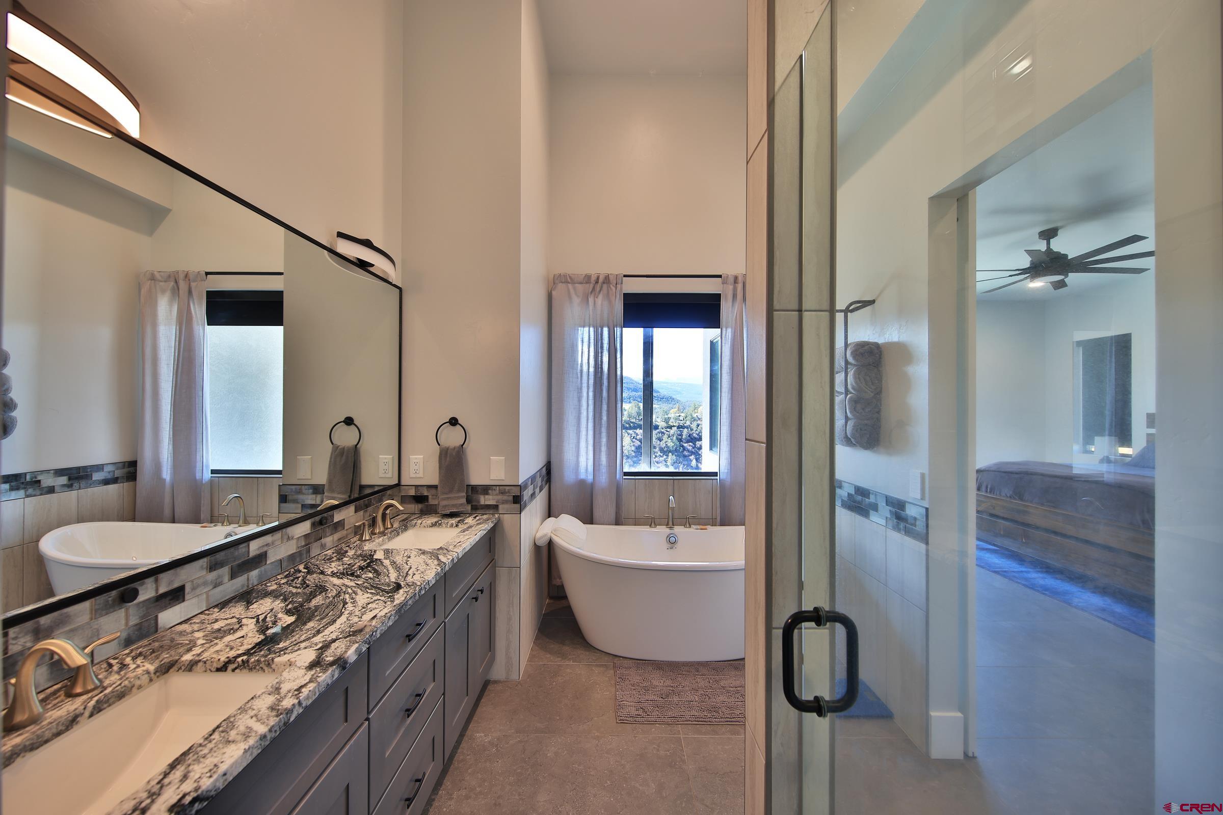 12471 54 7/10 Road Molina, CO 81646 - Photo 25 of 35 a spacious bathroom with a tub sink and mirror
