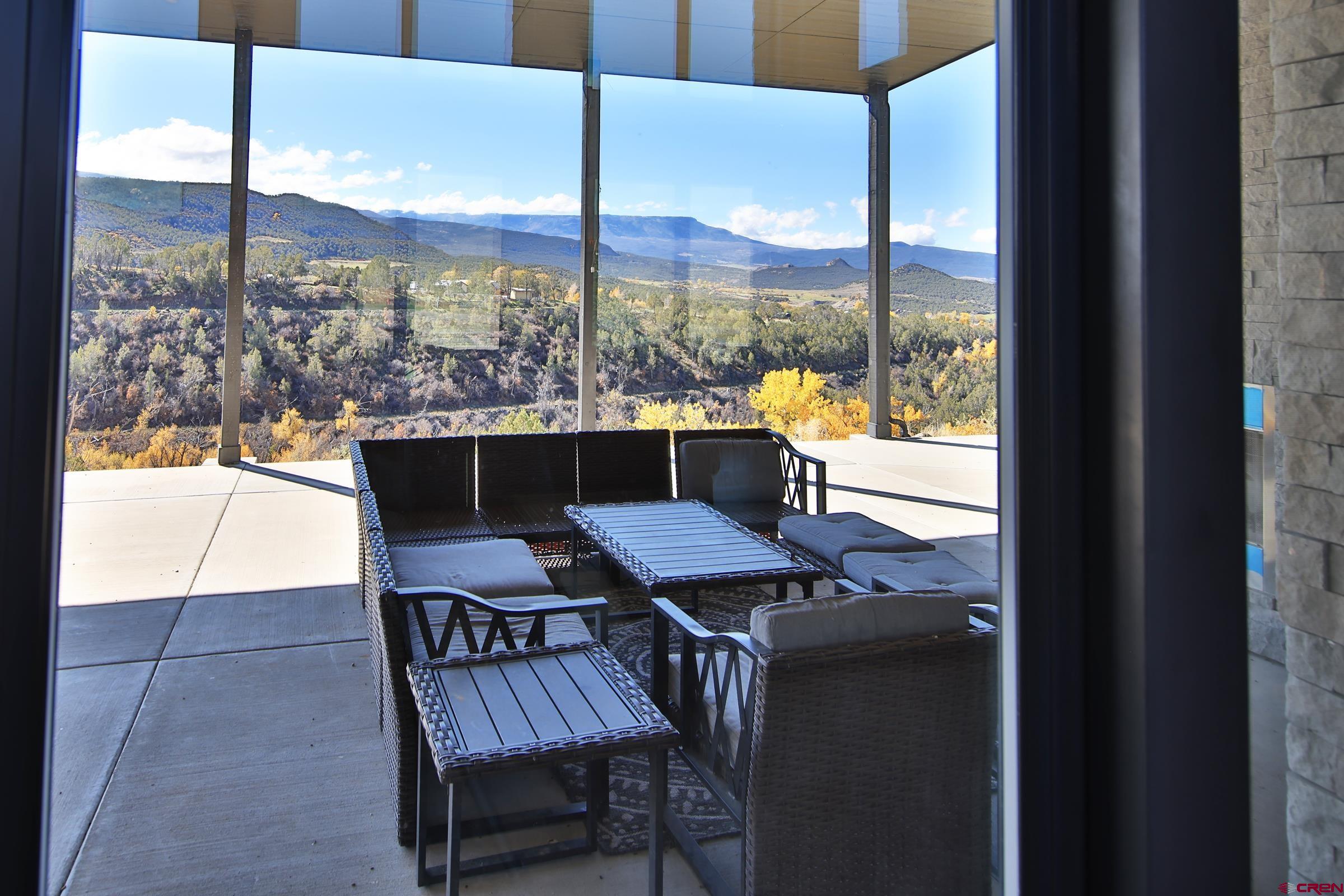 12471 54 7/10 Road Molina, CO 81646 - Photo 28 of 35 a view of a balcony with table and chairs