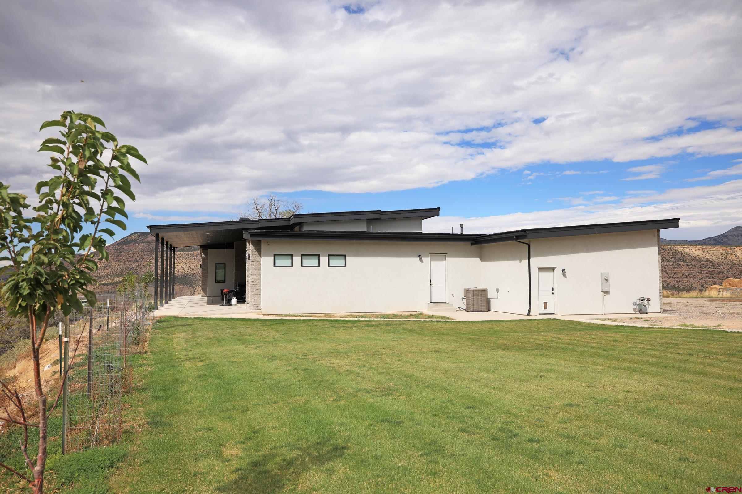 12471 54 7/10 Road Molina, CO 81646 - Photo 32 of 35 a view of a yard with a barn
