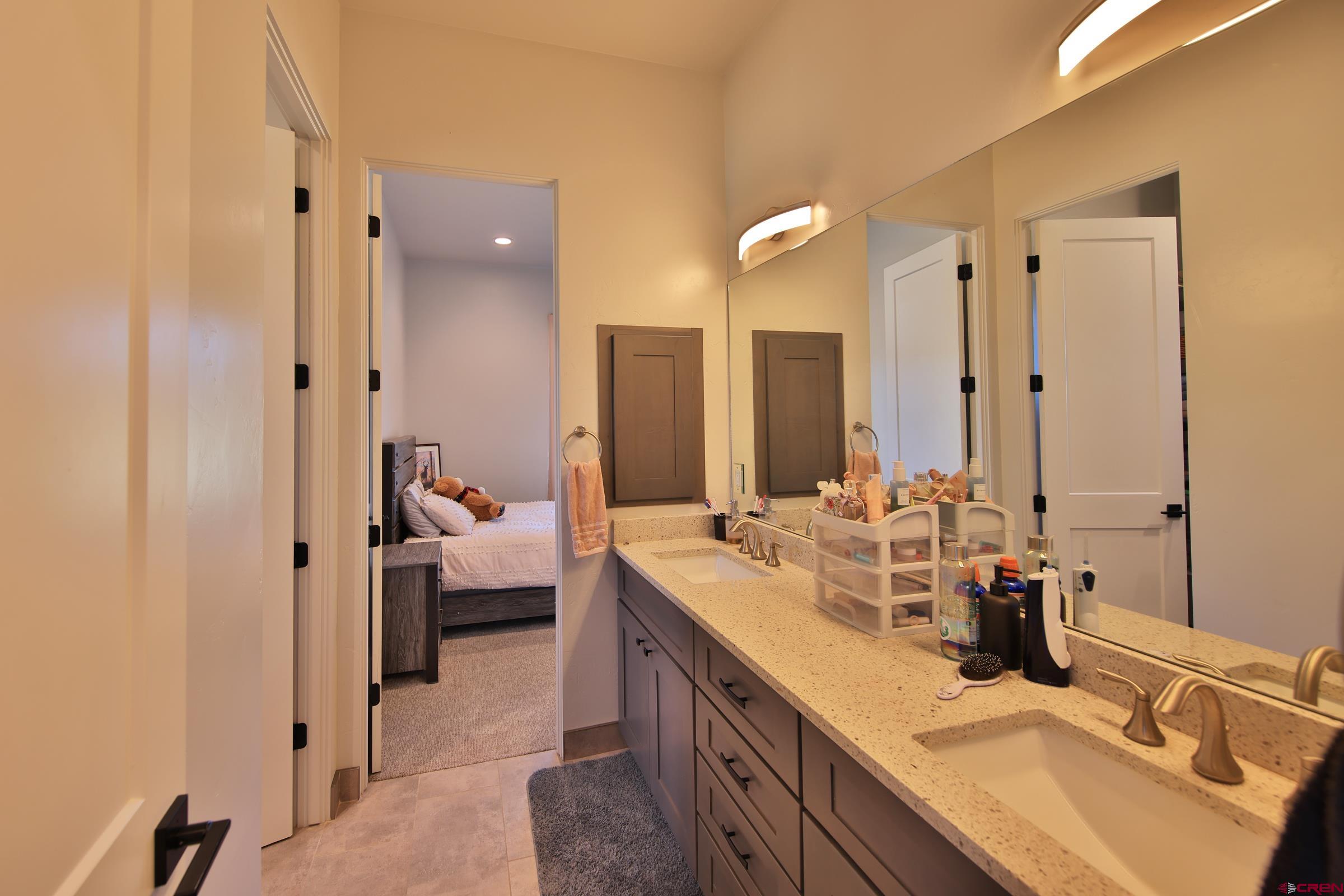 12471 54 7/10 Road Molina, CO 81646 - Photo 4 of 35 a en suite bathroom with double vanity and a mirror