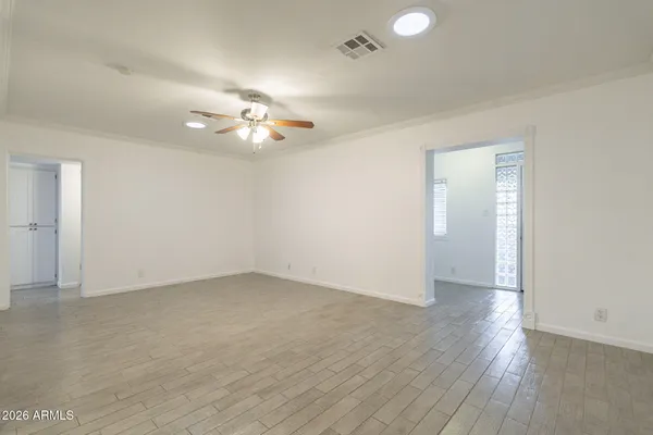 a kitchen with stainless steel appliances granite countertop a refrigerator a sink dishwasher a stove and white countertops with wooden floor