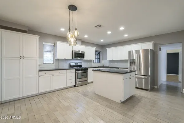 a kitchen with a sink a counter space and a refrigerator