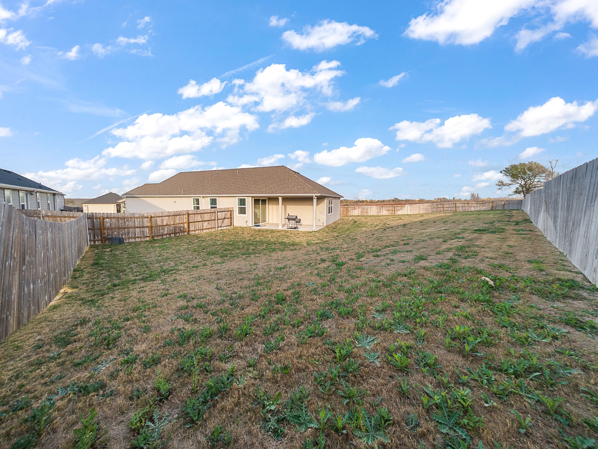 20811 Phebe Foster Street Manor, TX 78653 - Photo 31 of 40 Rear view of property with a patio and a fenced backyard
