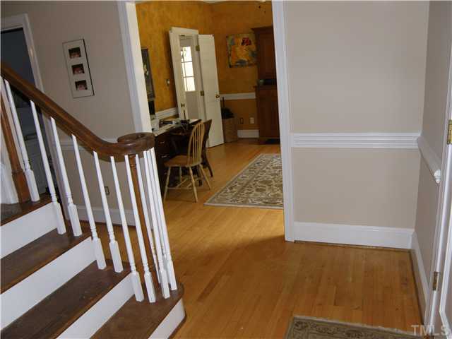 2508 Ashley Court Raleigh, NC 27607 - Photo 2 of 12 View of dining room from foyer, notice the chair railing thruout and the hardwood floors. Dining room is presently used for home office space.