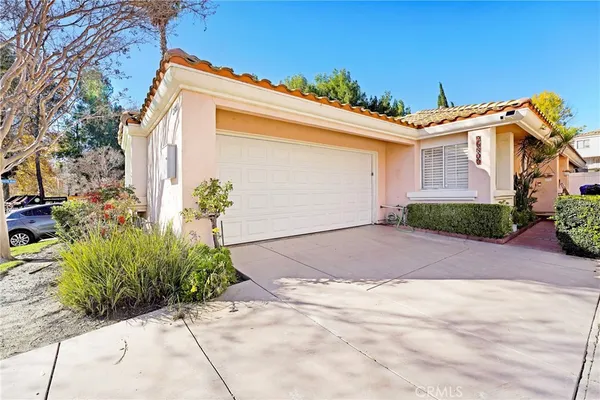 a front view of a house with a yard and a garage