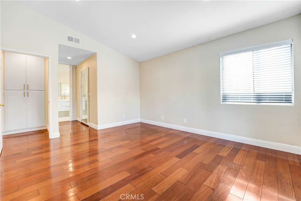25803 Browning Place Stevenson Ranch, CA 91381 - Photo 13 of 20 an empty room with wooden floor and windows