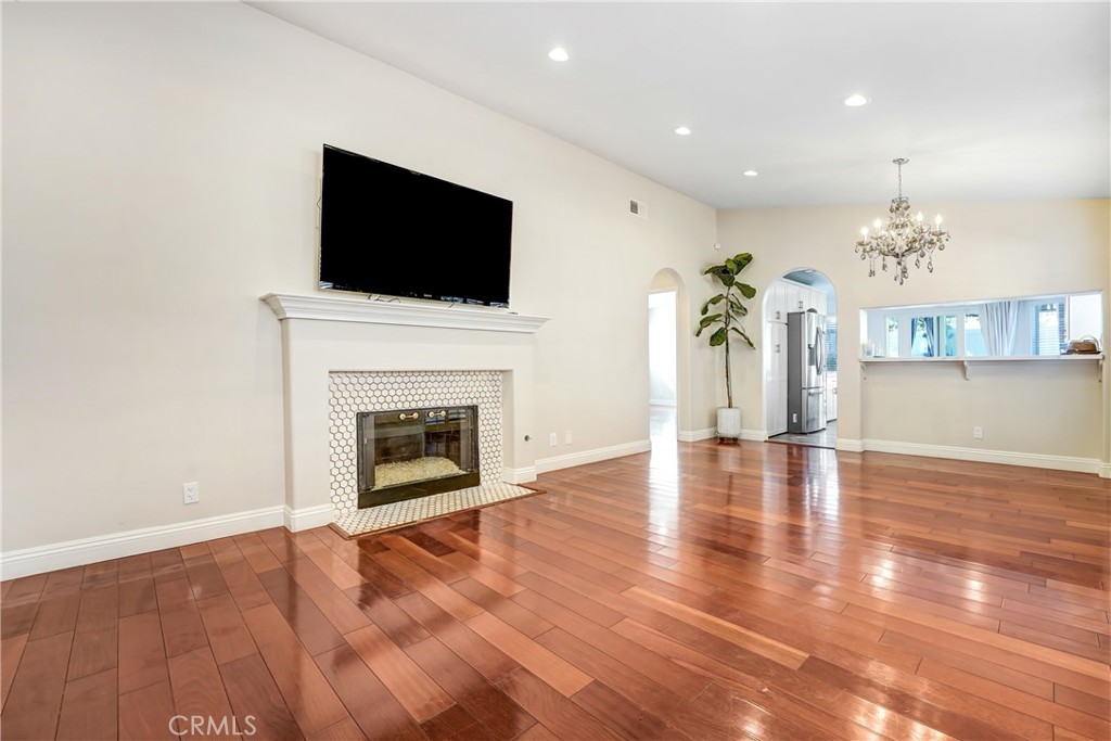 25803 Browning Place Stevenson Ranch, CA 91381 - Photo 20 of 20 a view of a livingroom with a fireplace a flat screen tv and staircase