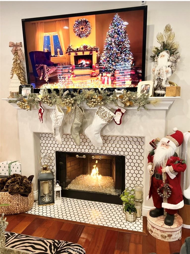 25803 Browning Place Stevenson Ranch, CA 91381 - Photo 3 of 20 a room with fireplace and wooden floor