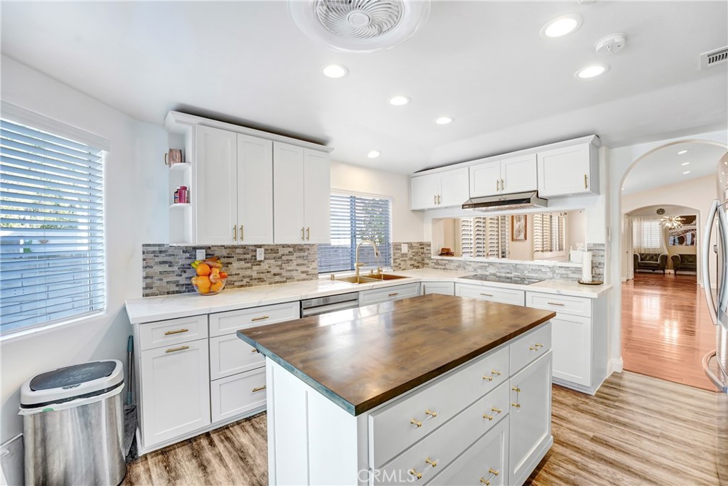 25803 Browning Place Stevenson Ranch, CA 91381 - Photo 7 of 20 a kitchen with a stove a sink and a refrigerator