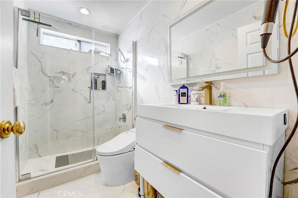 25803 Browning Place Stevenson Ranch, CA 91381 - Photo 9 of 20 a bathroom with a sink a toilet and shower