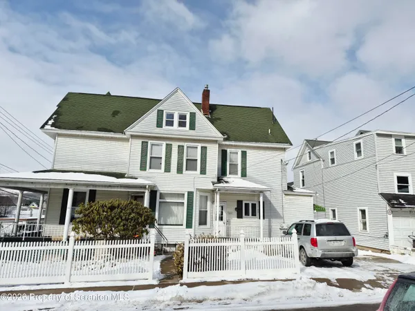 a front view of a residential apartment building with a yard