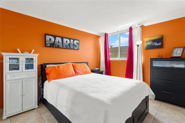 a bedroom with a bed and a dresser