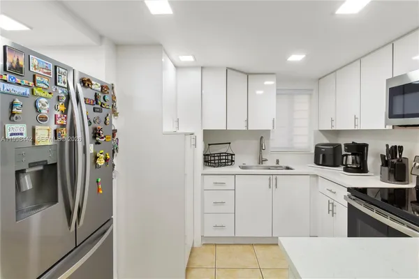 a kitchen with stainless steel appliances and cabinets