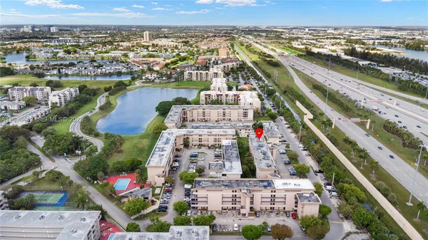 an aerial view of lake and residential houses with outdoor space