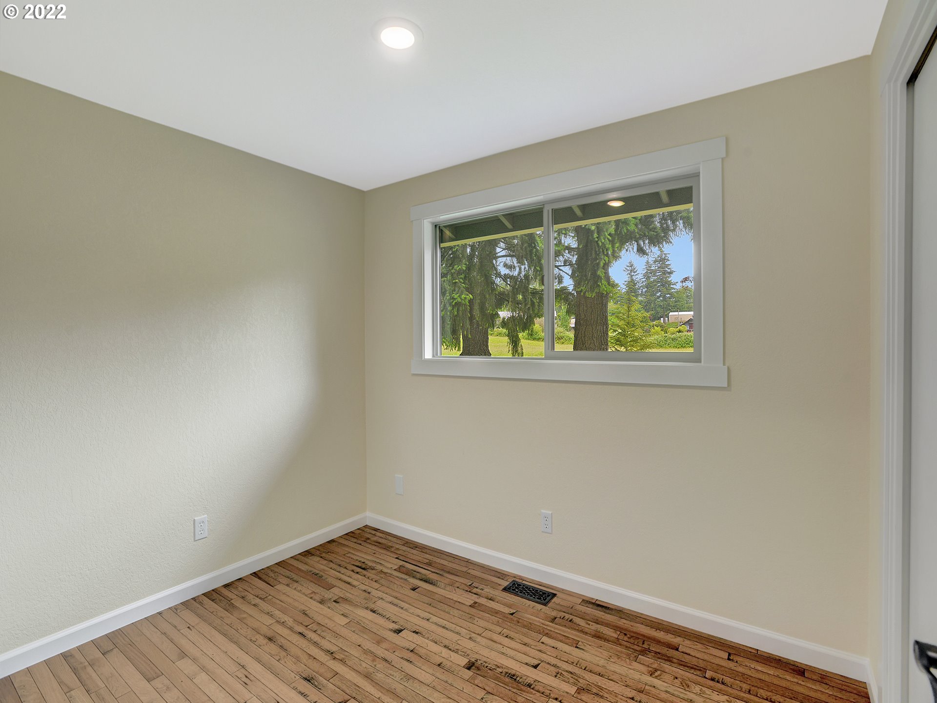 37490 Southeast Dunn Road Sandy, OR 97055 - Photo 26 of 29 a view of an empty room with wooden floor and a window