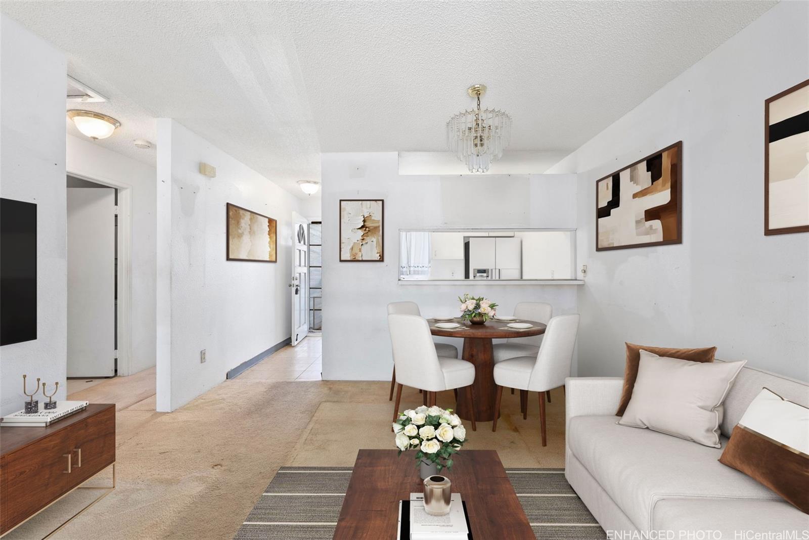 94-201 Lumiaina Place, Unit E202 Waipahu, HI 96797 - Photo 1 of 25 a living room with furniture and a flat screen tv