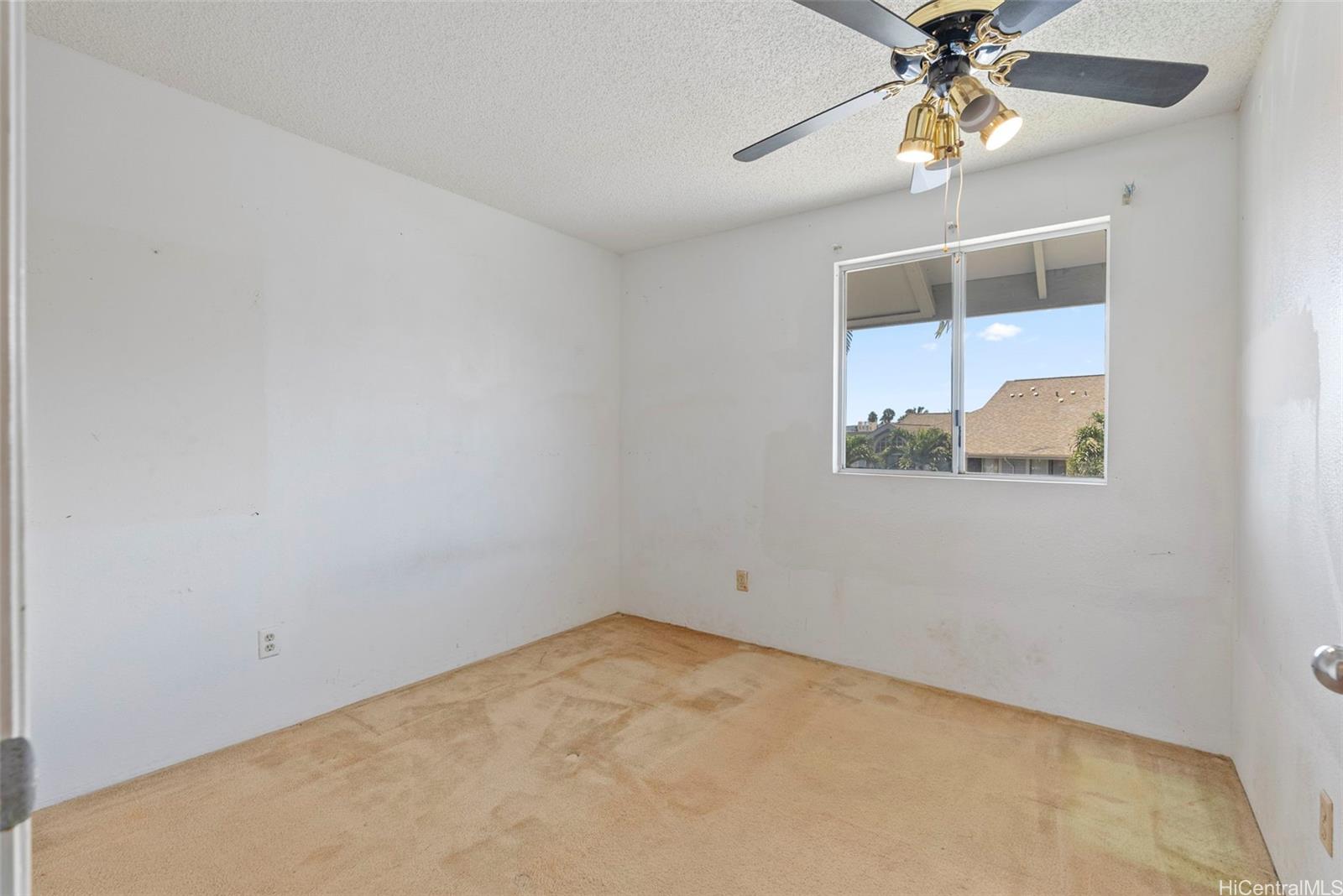94-201 Lumiaina Place, Unit E202 Waipahu, HI 96797 - Photo 15 of 25 an empty room with a window and a fan
