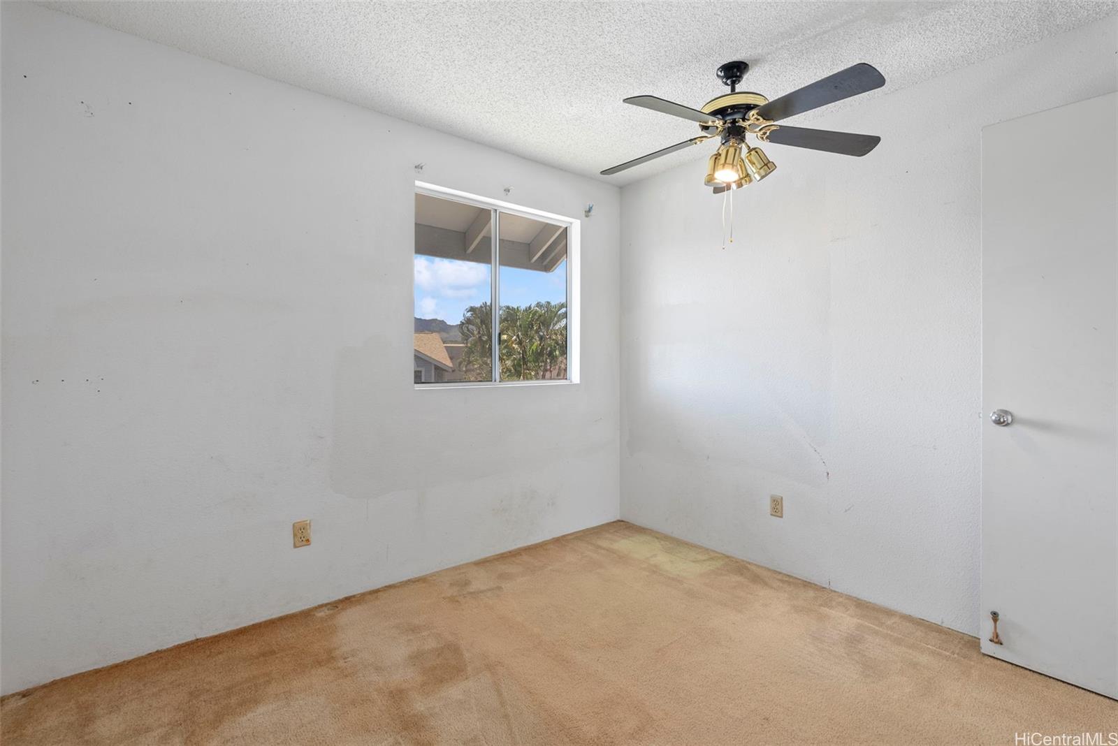 94-201 Lumiaina Place, Unit E202 Waipahu, HI 96797 - Photo 16 of 25 an empty room with a window